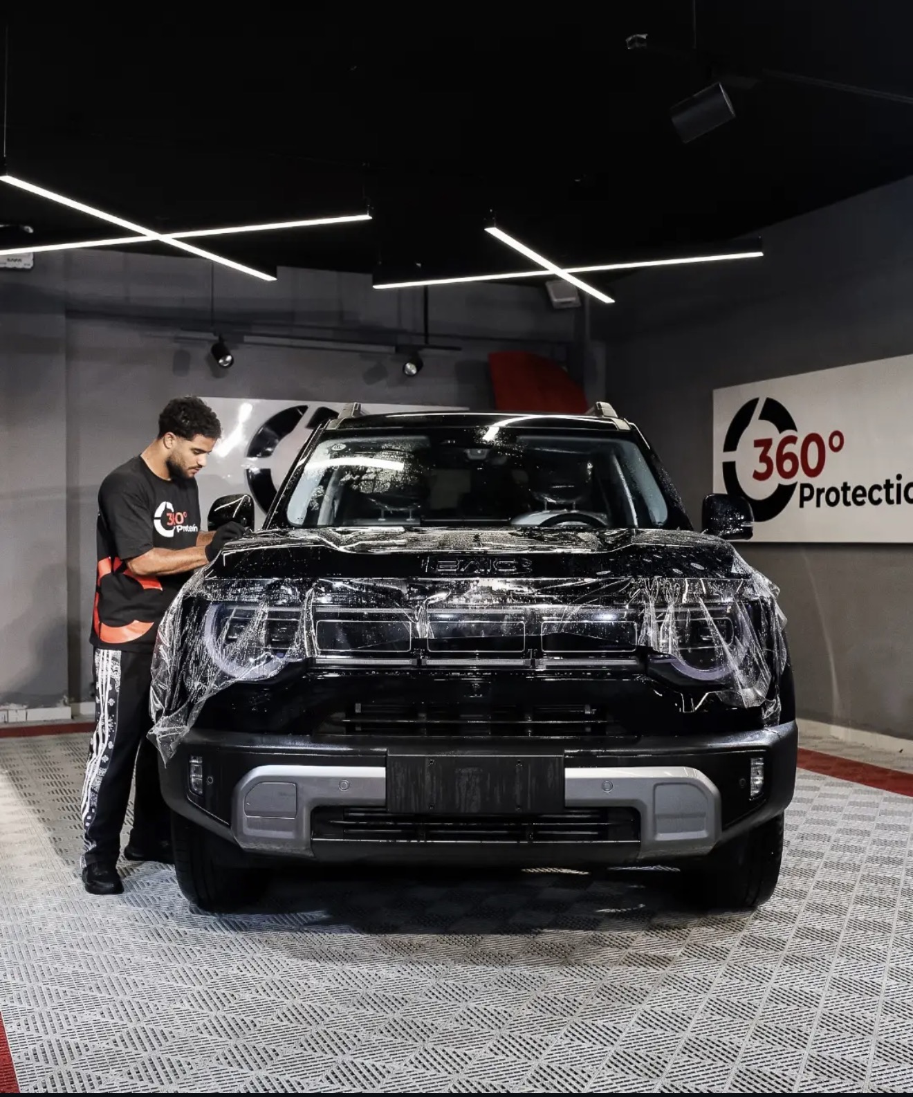 Black BMC SUV during paint protection film install